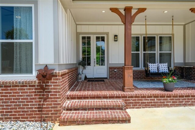 400 Fox Valley Dr, Monroe, GA 30656 - doorway to property featuring a porch, brick siding, french doors, and board and batten siding