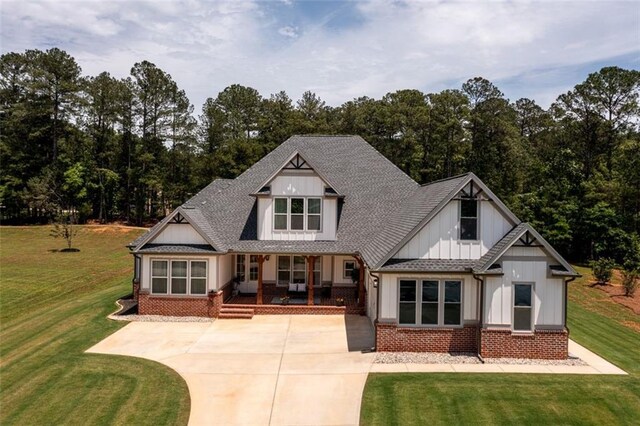 400 Fox Valley Dr, Monroe, GA 30656 - view of side of home featuring brick siding, a lawn, a shingled roof, and concrete driveway