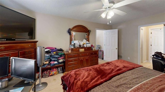 carpeted bedroom with a textured ceiling and ceiling fan