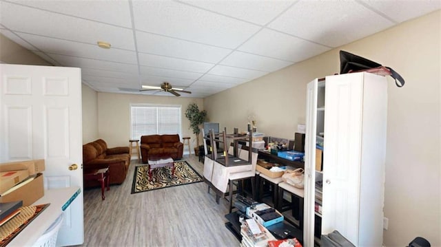 interior space featuring hardwood / wood-style floors, a paneled ceiling, and ceiling fan