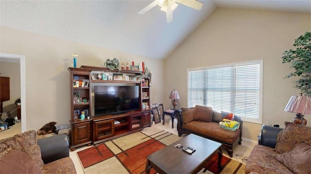 carpeted living room with ceiling fan and high vaulted ceiling