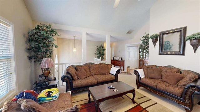 living room with lofted ceiling and light colored carpet