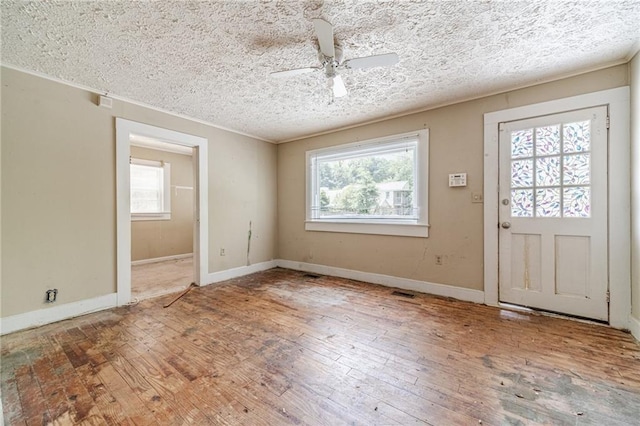 entrance foyer featuring baseboards, a ceiling fan, and hardwood / wood-style flooring