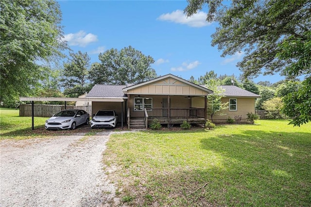 single story home featuring covered porch, driveway, fence, and a front yard