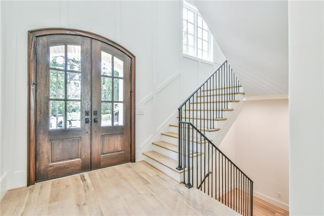 foyer entrance featuring french doors and wood-type flooring