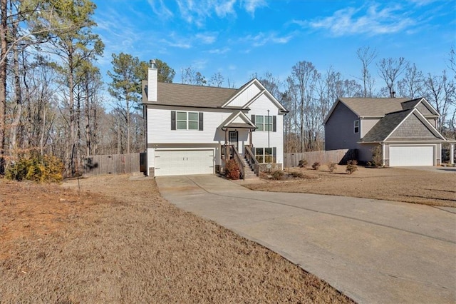 raised ranch with a garage and a front yard