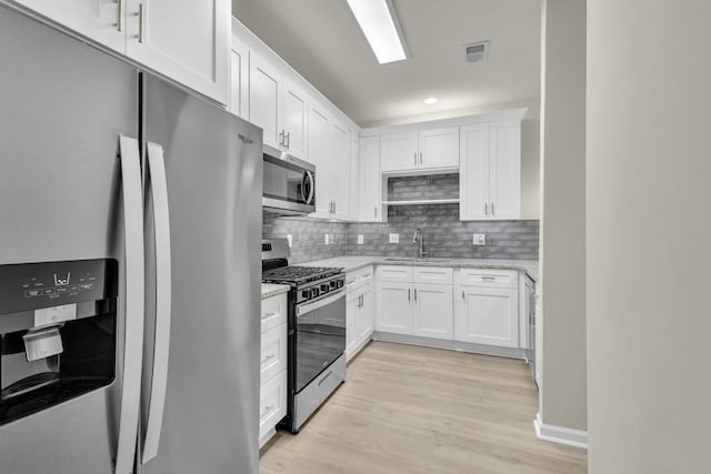 1249 Creek Forest Ln Bldg 8, Austell, GA 30106 - kitchen featuring stainless steel appliances, white cabinetry, light stone countertops, and recessed lighting