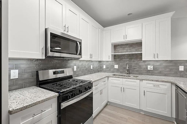 1249 Creek Forest Ln Bldg 8, Austell, GA 30106 - kitchen featuring stainless steel appliances, white cabinets, backsplash, and light stone counters