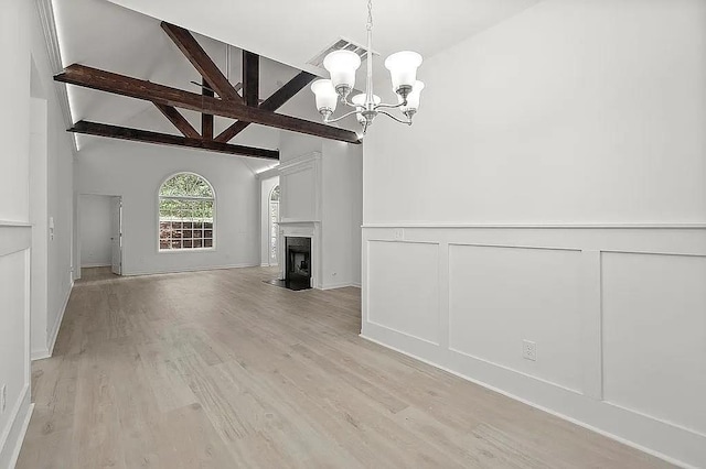 1249 Creek Forest Ln Bldg 8, Austell, GA 30106 - unfurnished living room with a chandelier, a fireplace, light wood-type flooring, a decorative wall, and wainscoting