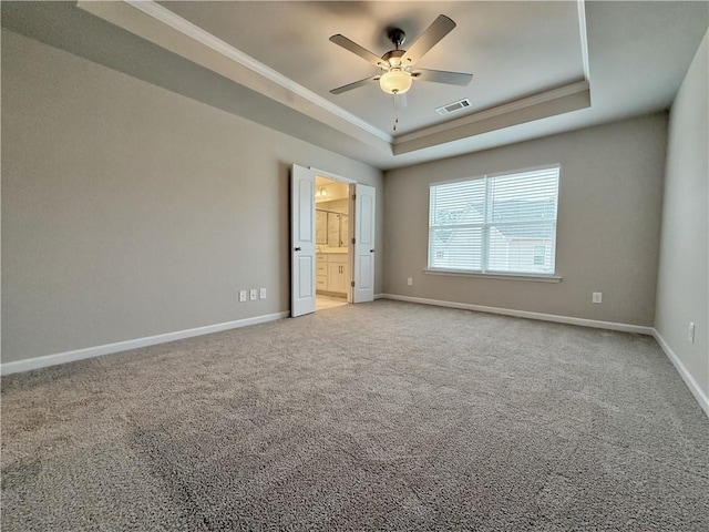 unfurnished room featuring crown molding, carpet flooring, a tray ceiling, and ceiling fan