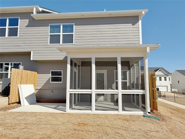 back of house featuring a patio and a sunroom