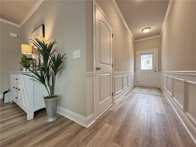 doorway with wood-type flooring and ornamental molding