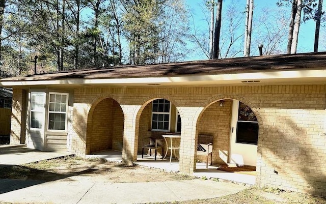 back of property featuring a patio