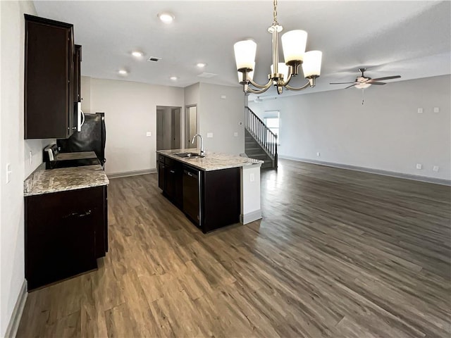 kitchen featuring dark wood-style floors, open floor plan, baseboards, and a sink