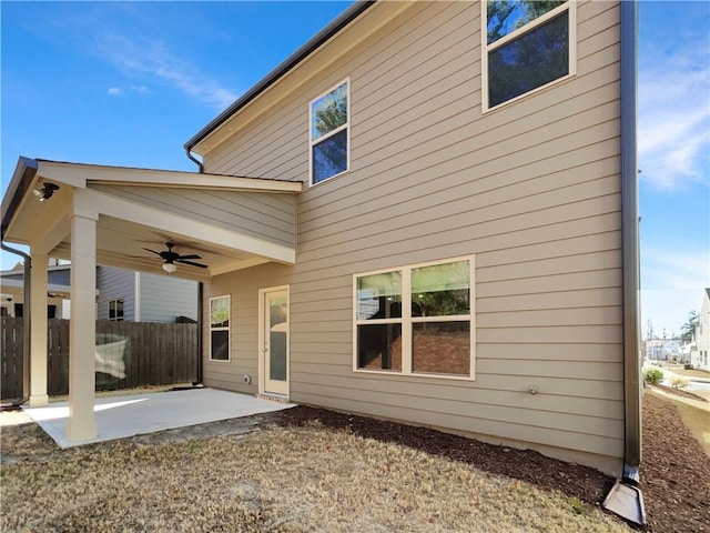 rear view of house with a patio, a ceiling fan, and fence