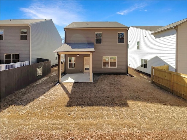 back of house featuring a patio and a fenced backyard