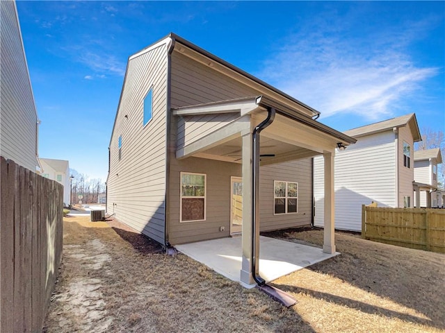 back of property featuring central AC unit, a patio area, and fence