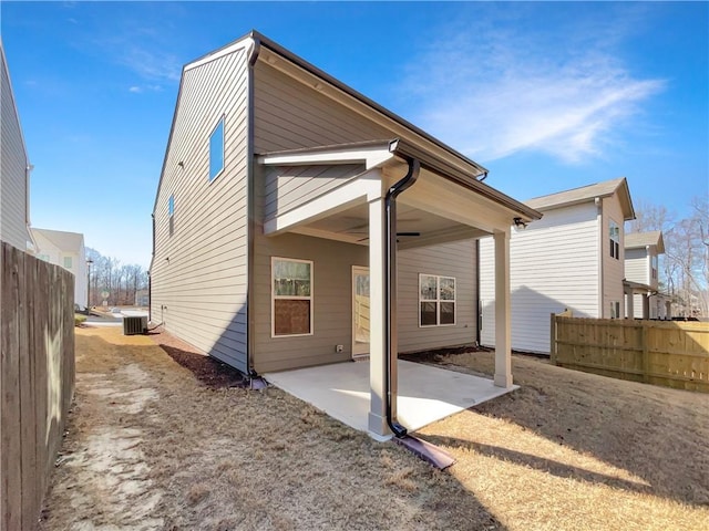 rear view of house featuring a patio area, central AC, and fence