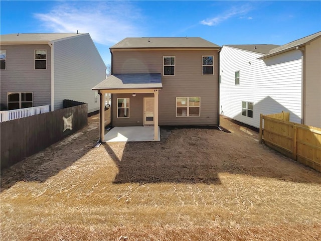 rear view of house featuring a patio area, central AC, and fence