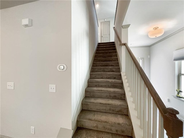 stairs featuring crown molding