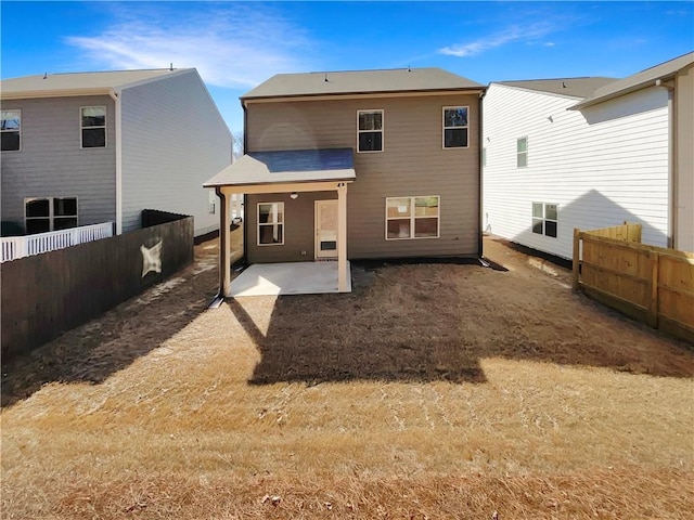 back of property with a patio and a fenced backyard