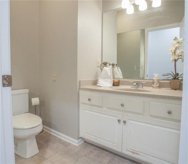 bathroom featuring vanity, toilet, and tile patterned floors