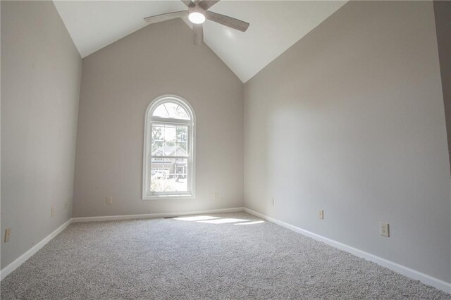 carpeted spare room with high vaulted ceiling and ceiling fan