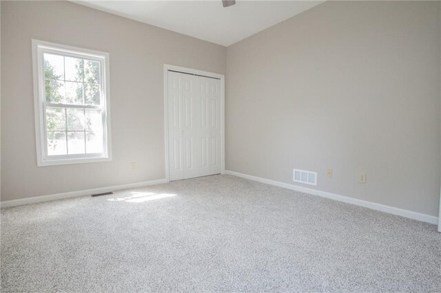 unfurnished room featuring carpet flooring and a healthy amount of sunlight