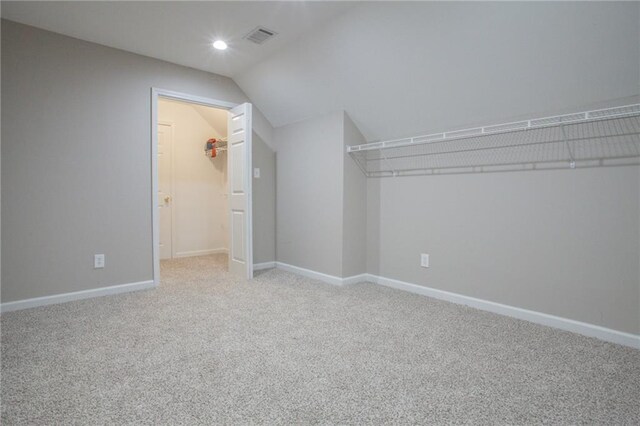 interior space featuring lofted ceiling and carpet