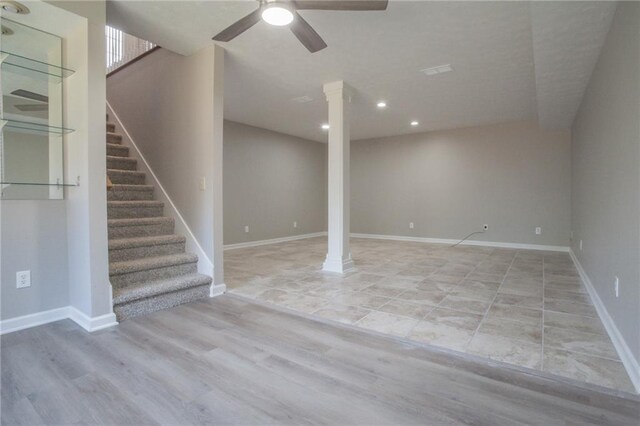 basement featuring ceiling fan and light hardwood / wood-style floors