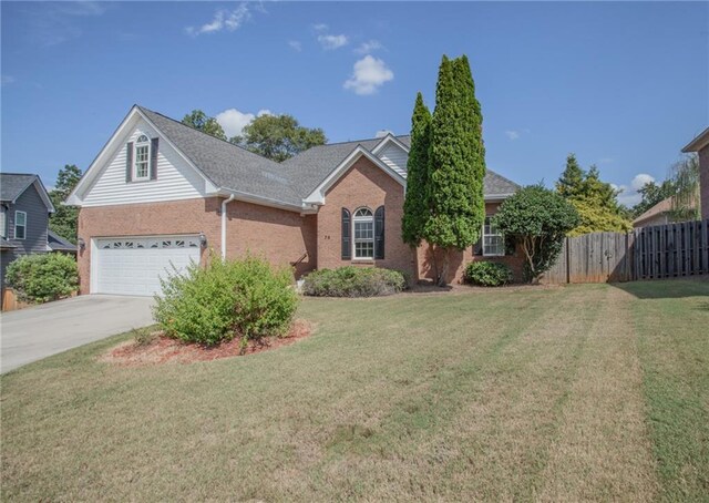 view of front of home with a garage and a front yard