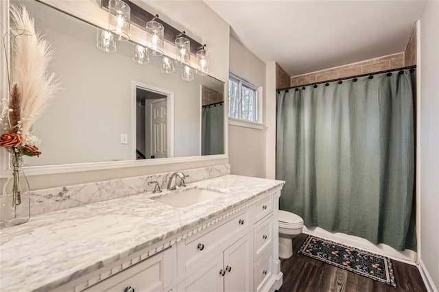 bathroom featuring vanity, hardwood / wood-style floors, a shower with curtain, and toilet