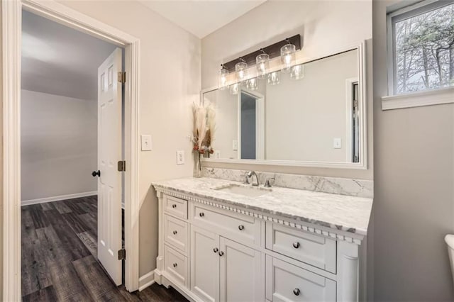 bathroom with vanity, toilet, and wood-type flooring