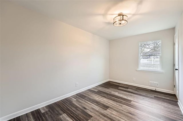 unfurnished room featuring dark wood-type flooring