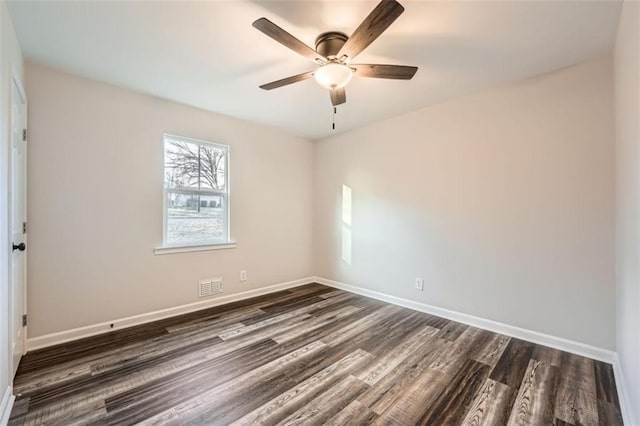 empty room with dark hardwood / wood-style flooring and ceiling fan