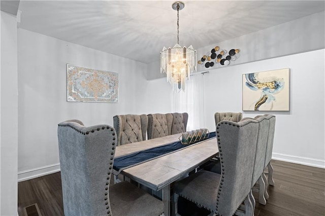 dining room featuring a notable chandelier and dark wood-type flooring