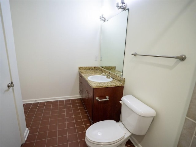 bathroom featuring tile patterned flooring, toilet, vanity, and baseboards