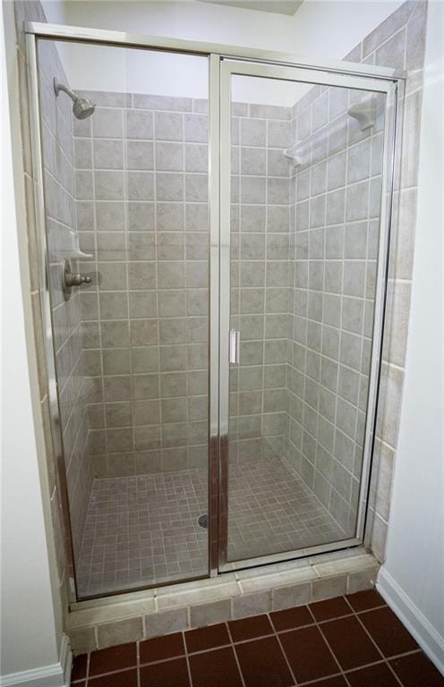 full bath featuring tile patterned flooring and a stall shower