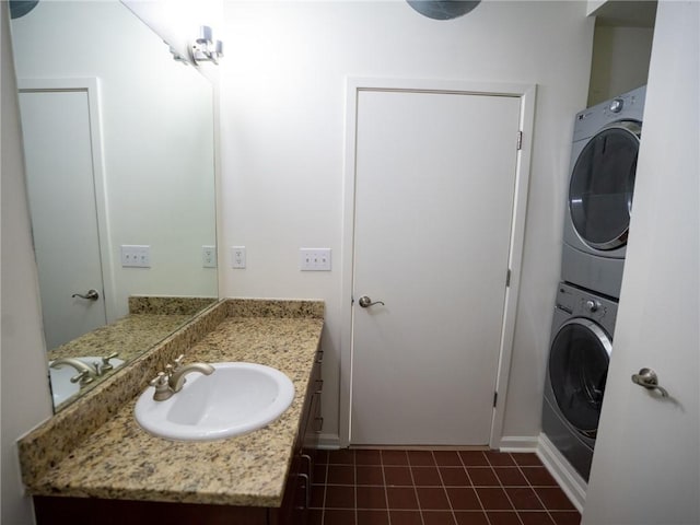 bathroom with stacked washer / dryer and vanity