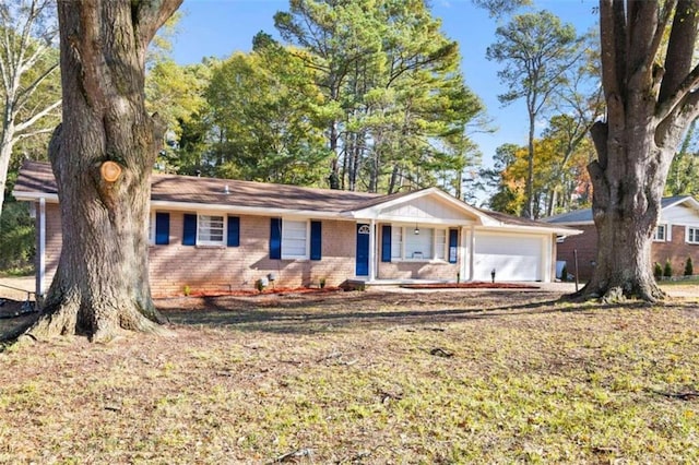 ranch-style house with covered porch and a garage