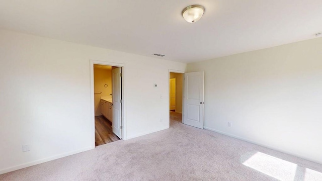 131 Andria Way, Cartersville, GA 30120 - unfurnished bedroom with light carpet, baseboards, and connected bathroom