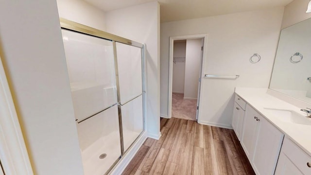 131 Andria Way, Cartersville, GA 30120 - bathroom featuring vanity, a shower stall, wood finished floors, and a walk in closet