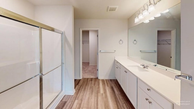 131 Andria Way, Cartersville, GA 30120 - bathroom with a spacious closet, vanity, a shower stall, and wood finished floors