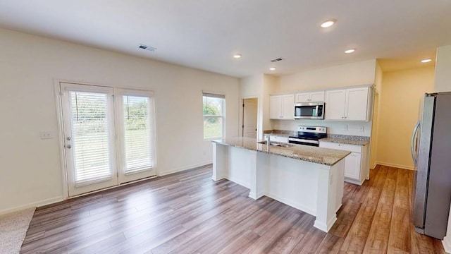131 Andria Way, Cartersville, GA 30120 - kitchen with appliances with stainless steel finishes, white cabinetry, light stone counters, light wood-style flooring, and recessed lighting
