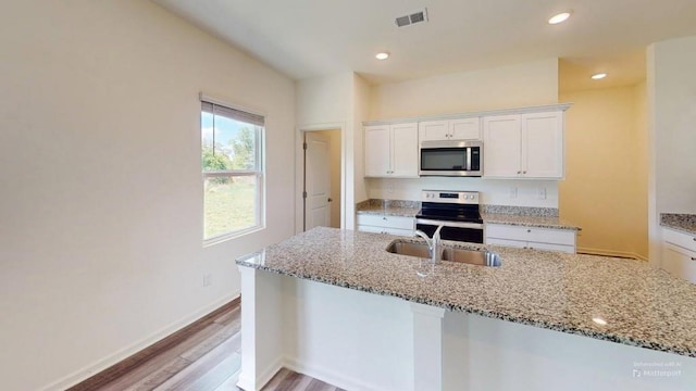 131 Andria Way, Cartersville, GA 30120 - kitchen featuring stainless steel appliances, light wood-type flooring, white cabinets, light stone countertops, and a sink