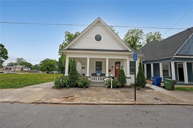 greek revival inspired property with a porch and a front yard