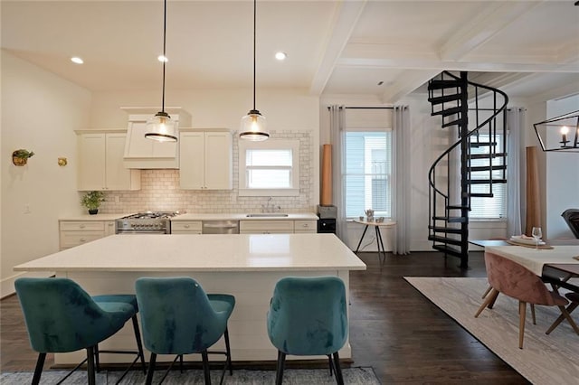 kitchen with a sink, appliances with stainless steel finishes, decorative backsplash, and light countertops