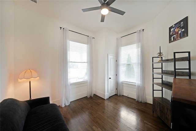 sitting room with baseboards, ceiling fan, and wood finished floors