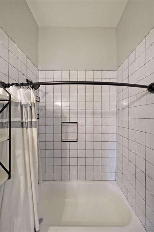 bathroom with shower / bath combination with curtain