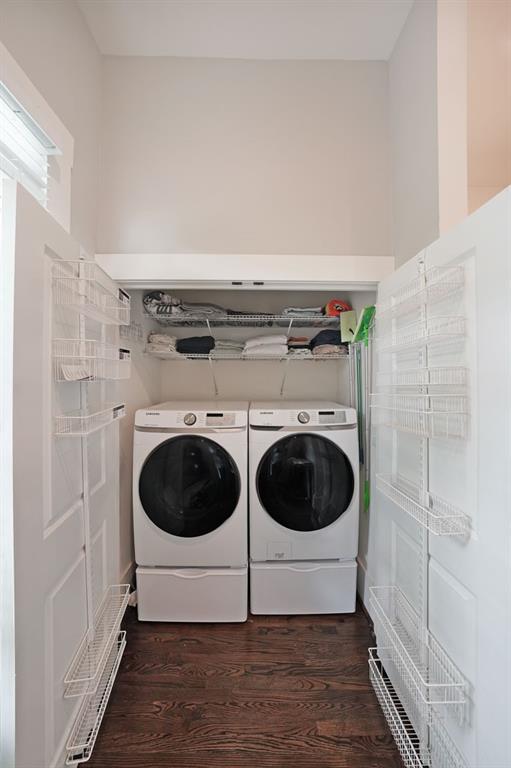 laundry room featuring dark wood-type flooring and washer and dryer